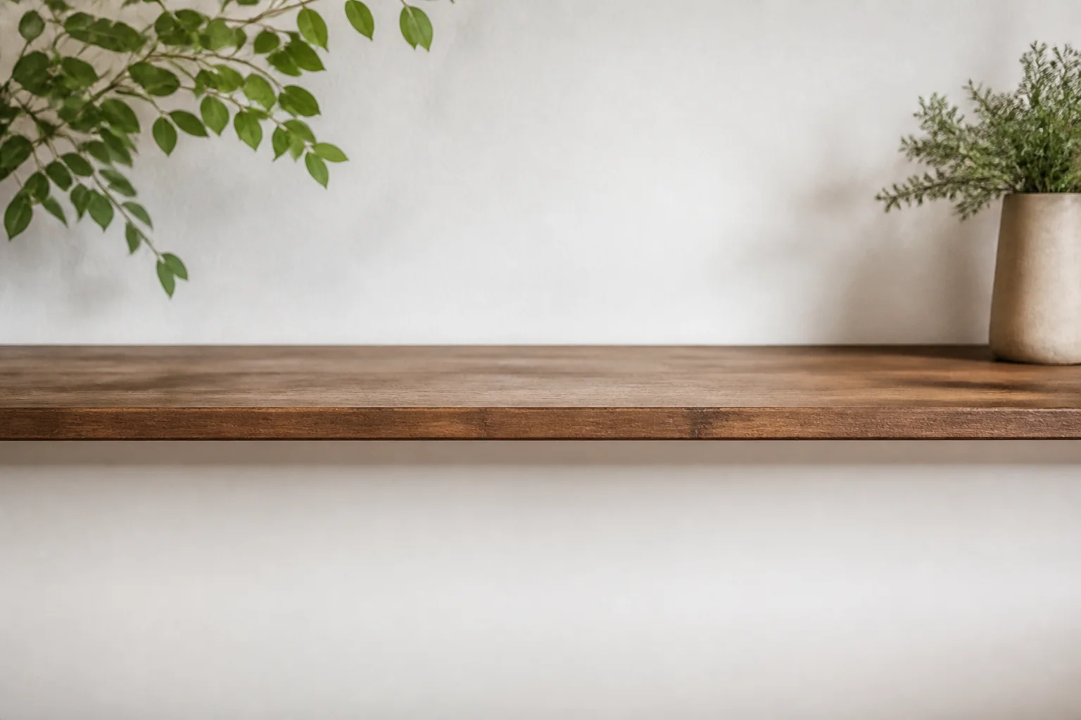 Wall-mounted fold-down table folded away against a wall
